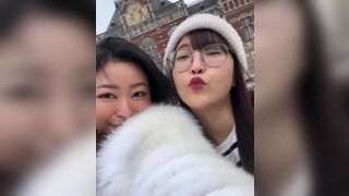 Asian Cutie With Her Friend Giving a Kiss On Cam Video