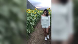 Sexy Asian In a Sexy Dress Showing Off While Walking On a Sunflower Field Video